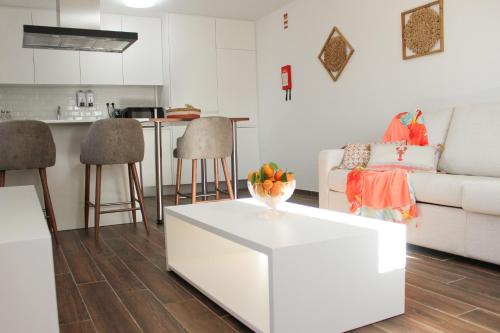 a living room with a white couch and a table at Monte do Couto in Albufeira