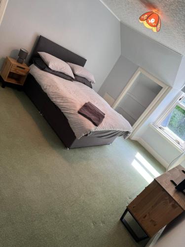 a bedroom with a bed and a window at 4 bed Harbour House in Wick