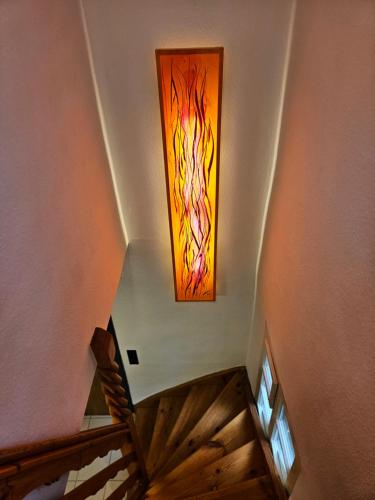 a staircase with a stained glass window on the wall at Onkel Willis Hütte in Velden am Wörthersee