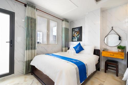 a bedroom with a large bed and a mirror at Mai Phương - RUBY SAIGON HOTEL in Ho Chi Minh City