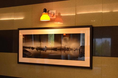 a picture frame hanging on a wall with a light at Hotel Elorrio in Elorrio