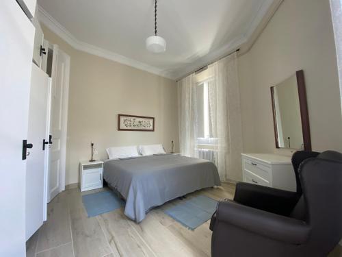 a bedroom with a bed and a chair in it at Principal Casa Pomar in Camprodon