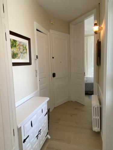 a white bathroom with a white dresser and a door at Principal Casa Pomar in Camprodon