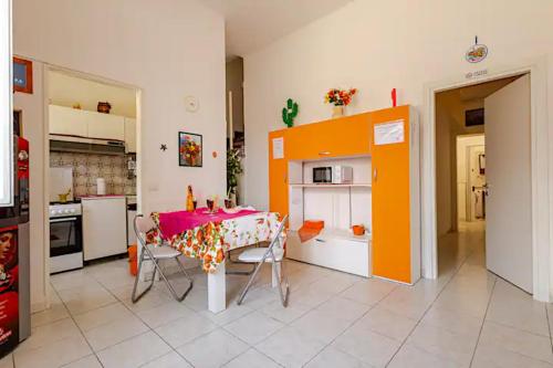 a kitchen with a table and a kitchen with orange at Al Baglio in Scoglitti