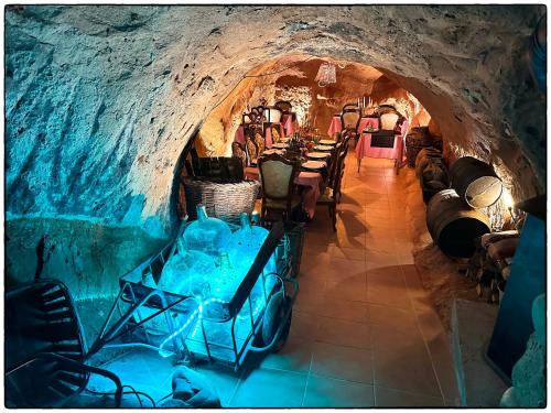 a room with tables and chairs in a cave at Riojania Heredad in Santa Eulalia Bajera