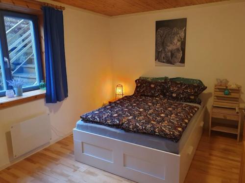 a bedroom with a bed in a room with a window at Kellergeschosswohnung mit Aussicht und Terasse in Strand