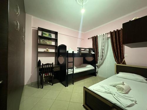 a bedroom with two beds and a bunk bed at Bega Apartment in Sarandë