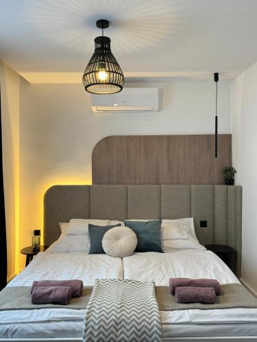 a large bed with two pillows on it in a bedroom at Naluri Apartman II in Balatonboglár