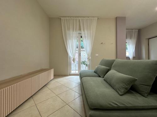 a living room with a couch and a window at Cinelli Apartment Stio Cilento in Magliano Nuovo