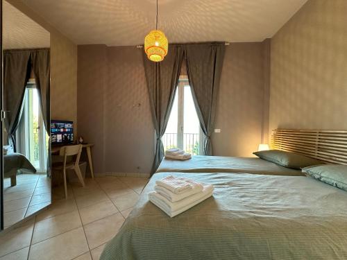 a bedroom with a large bed with towels on it at Cinelli Apartment Stio Cilento in Magliano Nuovo