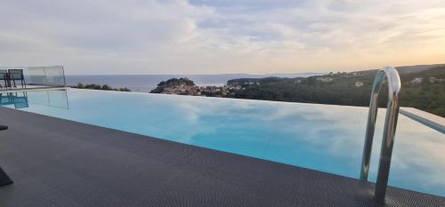a swimming pool with a view of the ocean at Blue Lilac Villas in Parga