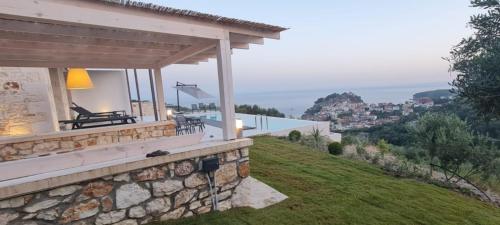 a stone house with a view of the ocean at Blue Lilac Villas in Parga