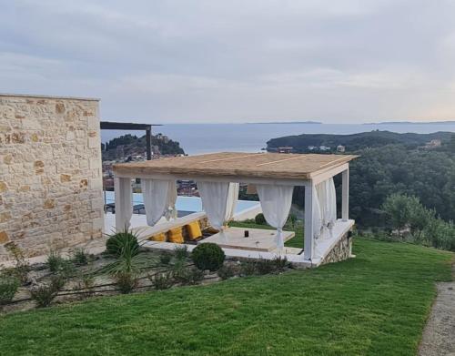 a gazebo on top of a hill with the ocean at Blue Lilac Villas in Parga
