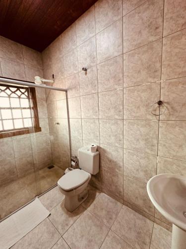 a bathroom with a toilet and a sink at Pousada Despertar de Minas in Tiradentes
