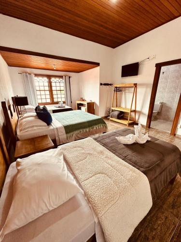 a bedroom with two beds in a room at Pousada Despertar de Minas in Tiradentes