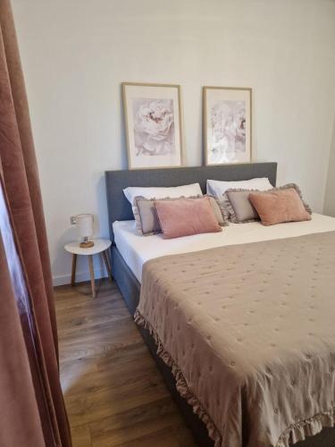 a bedroom with a large bed with pillows on it at Rustic House Konfidenca in Biograd na Moru