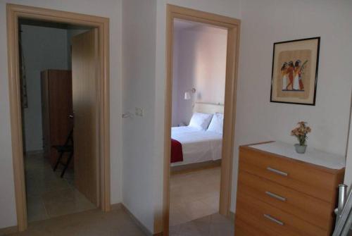 a bedroom with a bed and a dresser and a mirror at Hara House in Monolithos Rhodes in Monólithos
