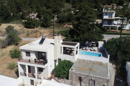 an aerial view of a white house with a swimming pool at Hara House in Monolithos Rhodes in Monólithos