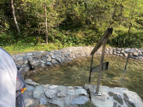 a wooden cross in a pond of water at Adventure Panorama Hochalp Top 7 in Warth am Arlberg