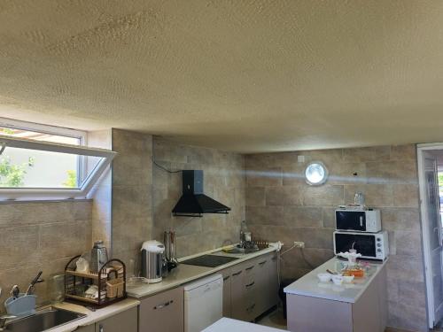a kitchen with a sink and a microwave at Batumi Aparthotel 22D in Batumi