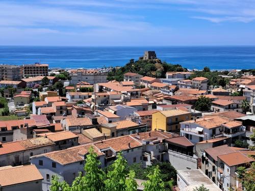 an overview of a city with buildings and the ocean at levante rooms in Scalea
