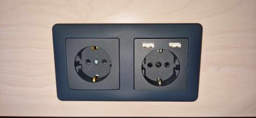 an electrical outlet with two faces on it at Maddis in Kirkjubæjarklaustur