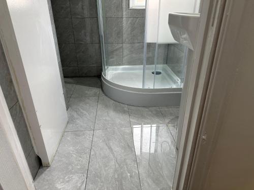 a bathroom with a shower and a toilet and a sink at Double Room With Free WiFi Keedonwood Road in Bromley