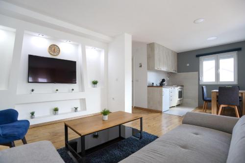 a living room with a couch and a table at Airport Stay Apartments in Surčin