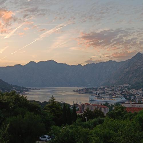 a view of a city and a lake at sunset at Radgost Kotor Apartments in Kotor