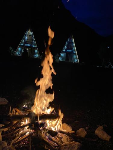 a bonfire in front of a building at night at Monark Villas in Shkodër