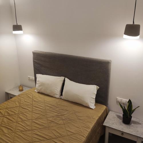 a bedroom with a bed with two pillows on it at Il Margio Studio in Tinos Town