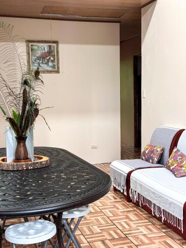 a living room with a table and a couch at Cabañas Río Escondido en La Fortuna in Fortuna