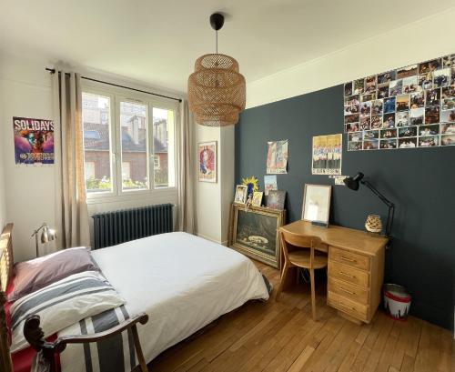une chambre avec un lit, un bureau et une fenêtre dans l'établissement Maison familiale - 20 mn Centre Paris et Stade de France- 5 Chambres, à Saint-Ouen