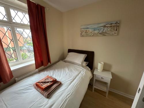 a small bed in a bedroom with a window at Hinckley Home Leysmill in Hinckley