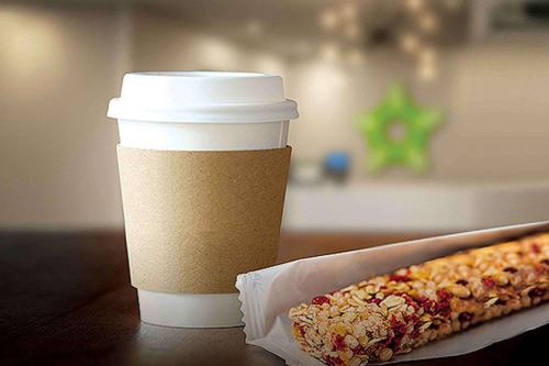 a cup of coffee and a hot dog on a table at Extended Stay America Premier Suites - Pittsburgh - Cranberry Township - I-76 in Cranberry Township