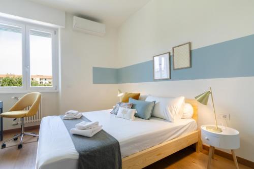 a bedroom with a bed with a desk and a chair at Milan Comfort Apartment in Milan
