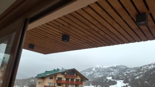 a view of a building with mountains in the background at DEPARTAMENTOS TERMAS DE CHILLAN in Nevados de Chillan