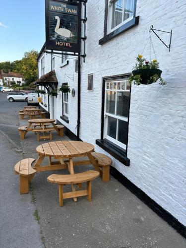 a row of picnic tables outside of a building at The White Swan Hotel in Hunmanby