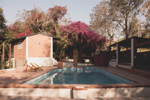 a swimming pool in a yard with a pavilion at Los Arboles in Villa Urquiza