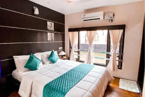 a bedroom with a large bed and a window at Northstar 1 Bedroom Ac Private Houseboat With All Meals in Alleppey