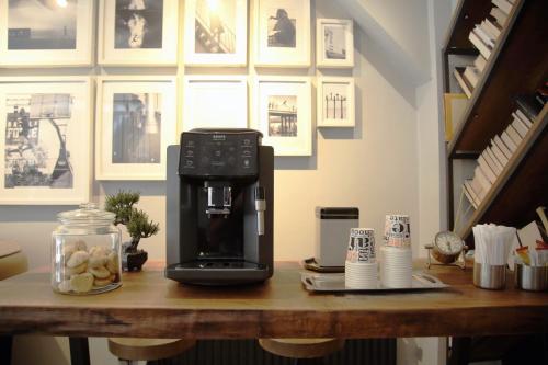 a coffee maker sitting on top of a wooden table at HOTEL BRONTE in Istanbul