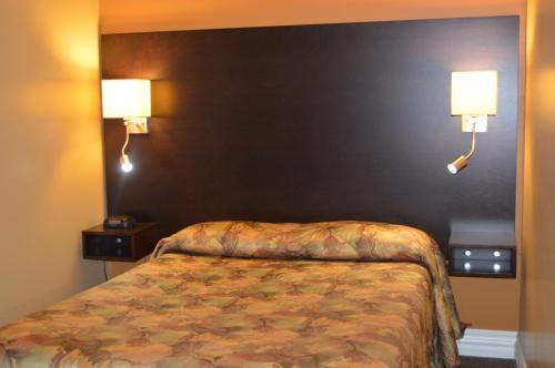 Katil atau katil-katil dalam bilik di Hôtel Maison Blanche