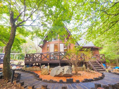 a house in the middle of a park with trees at Suite Villa NASU Shiki Resort in Nasu