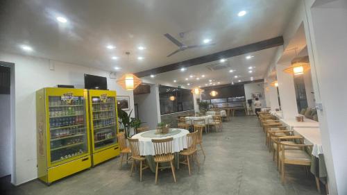 a dining room with tables and chairs in a restaurant at 古北御尚精品民宿Gubeiyushang in Gubeikou