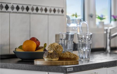 a counter with a plate of bread and glasses of water at Holiday Home Ajstrup Strandvej Malling Xi in Malling