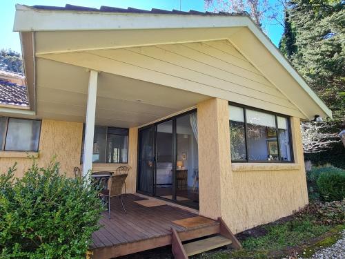 a screened in porch of a house with a deck at Waterfront in the Mountains in Wentworth Falls