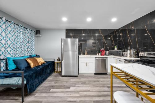 a kitchen with a blue couch and a refrigerator at Warm Heights 2BR with Pool & Free Parking in Houston