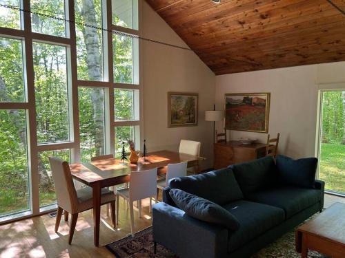 a living room with a couch and a table at Classic VT Aframe - Minutes to Mountains in Peru