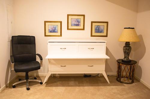 a desk with a chair and a lamp in a room at Beautiful Parkside Suite in Saint James