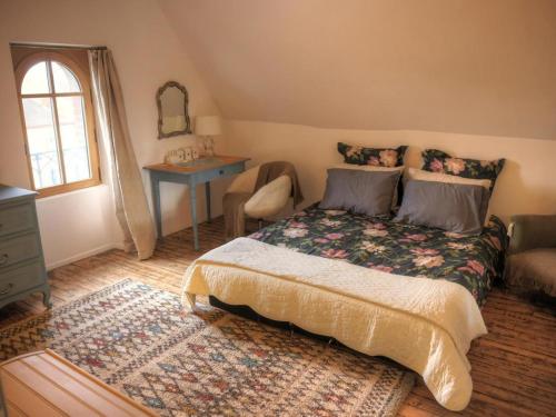 a bedroom with a bed and a chair and a window at Maison de Charme avec Terrasse et Animaux Acceptés à Moulins - FR-1-489-532 in Moulins